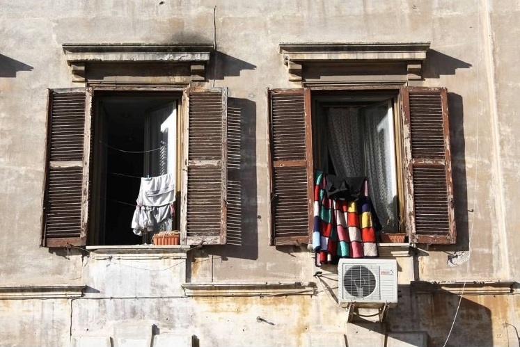twin windows with clothes hanging out to dry